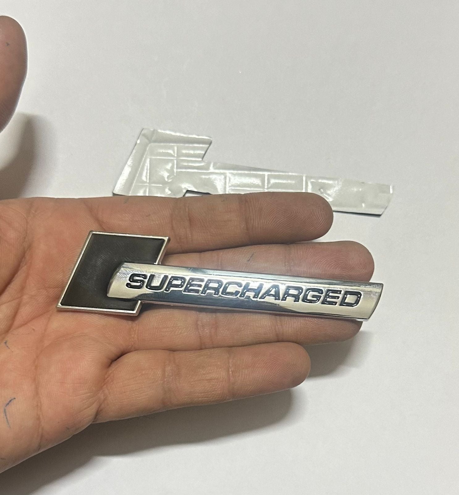 Supercharged (1PC) Logo Chrome Black. 10 x 2.6cm Car Bike Metal Supercharged Logo Car Emblem Premium 3D Badge Auto Racing Sport Sticker Grand Tourer Decal