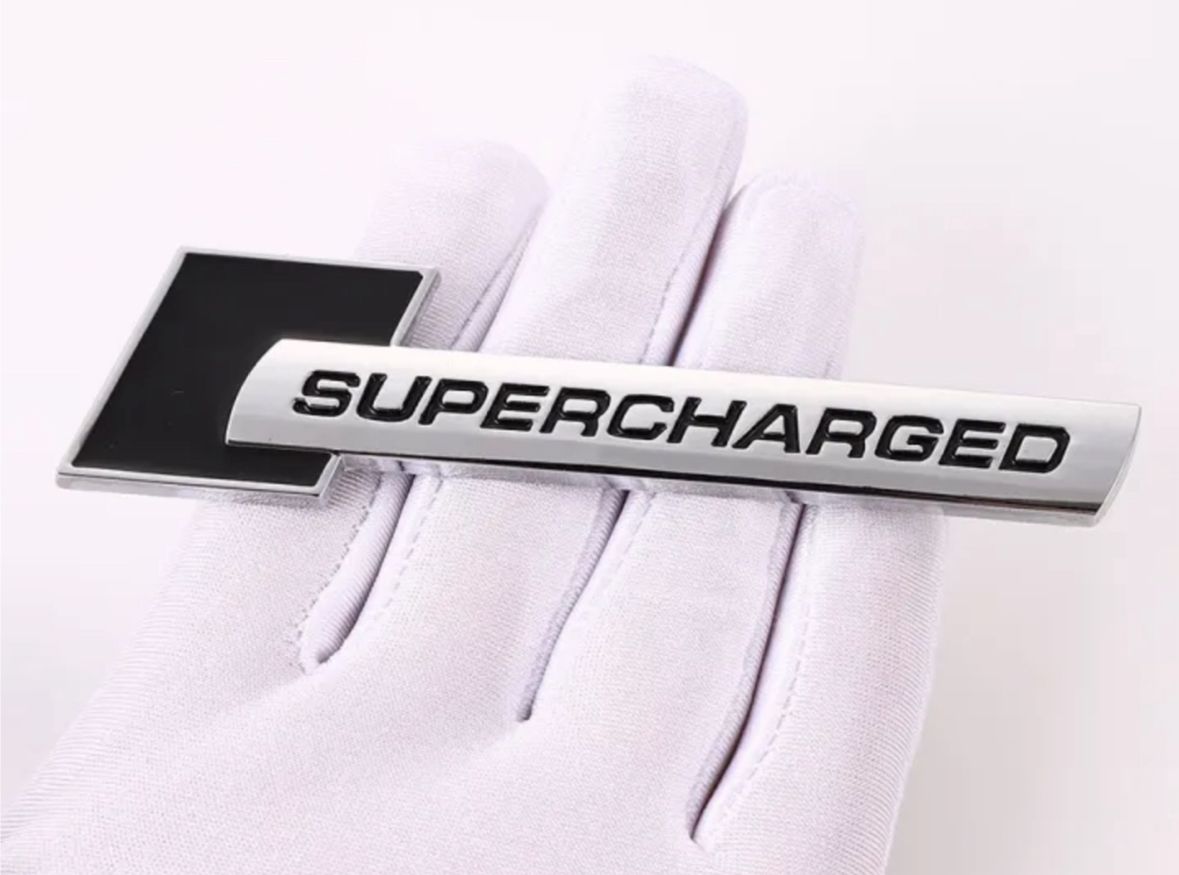 Supercharged (1PC) Logo Chrome Black. 10 x 2.6cm Car Bike Metal Supercharged Logo Car Emblem Premium 3D Badge Auto Racing Sport Sticker Grand Tourer Decal